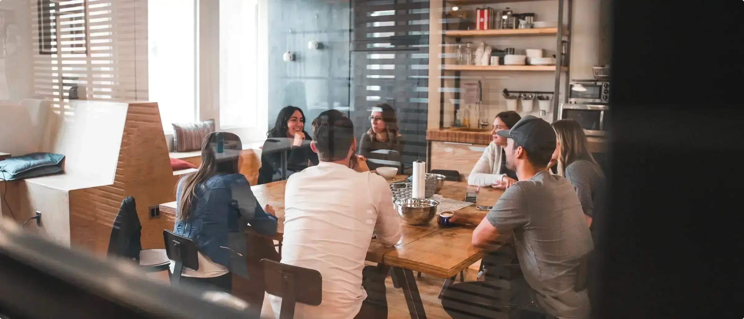 Group of people sitting round a table.