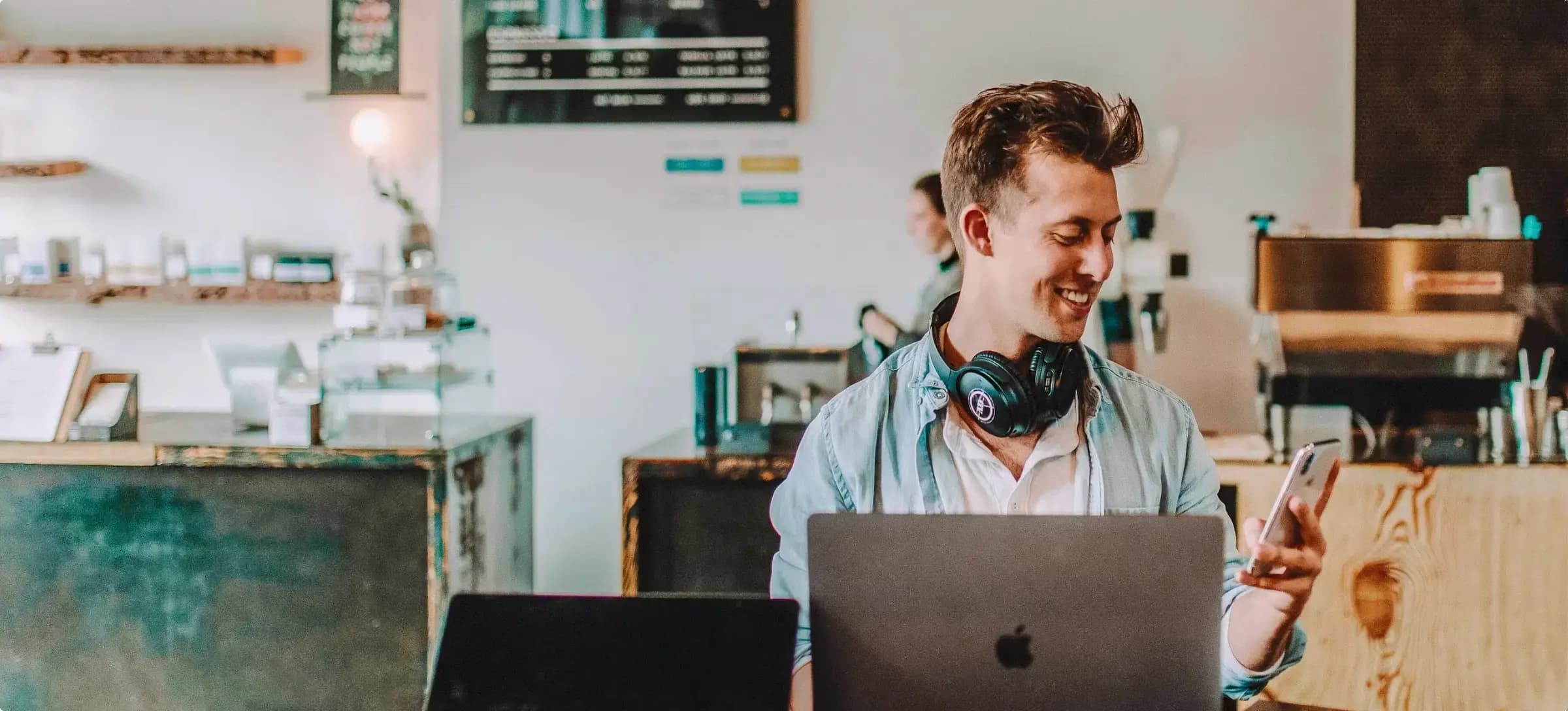 Man sitting in front of a laptop smiling